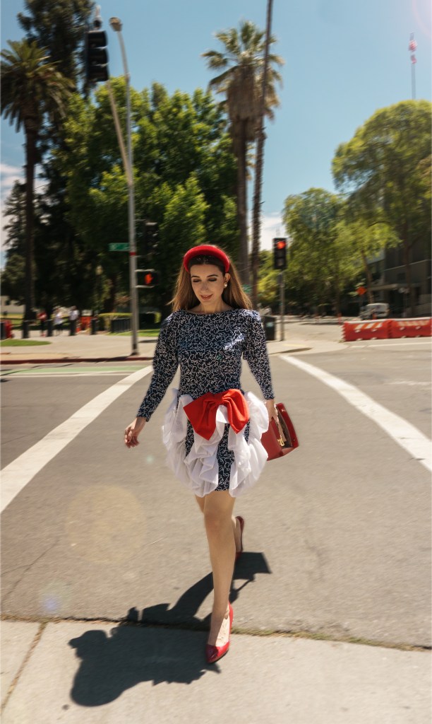 This red, blue and white dress was my mom's prom dress in the late 80s. She designed it and my grandma custom made it for her, with puffy sleeves, a big bow, and three-dimensional chiffon adornments. I wore it with a puffy headband, some red pumps, and an architectural red bag. I'm wearing it in front of the California State Capitol in Sacramento.