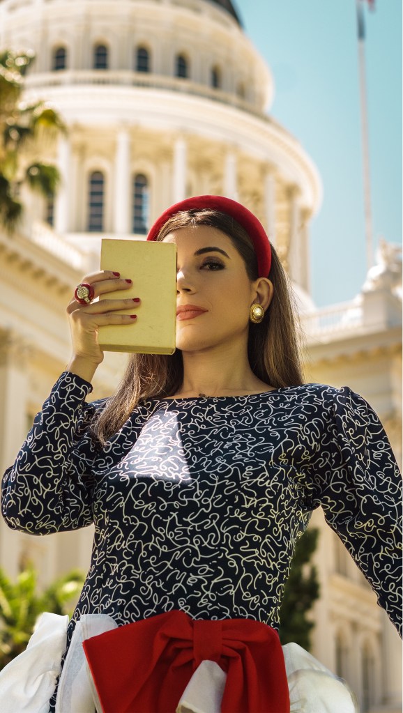This red, blue and white dress was my mom's prom dress in the late 80s. She designed it and my grandma custom made it for her, with puffy sleeves, a big bow, and three-dimensional chiffon adornments. I wore it with a puffy headband, some red pumps, and an architectural red bag. I'm wearing it in front of the California State Capitol in Sacramento.