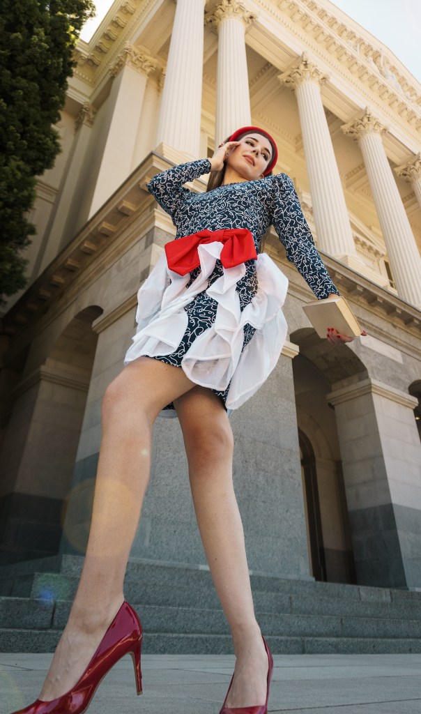 This red, blue and white dress was my mom's prom dress in the late 80s. She designed it and my grandma custom made it for her, with puffy sleeves, a big bow, and three-dimensional chiffon adornments. I wore it with a puffy headband, some red pumps, and an architectural red bag. I'm wearing it in front of the California State Capitol in Sacramento.