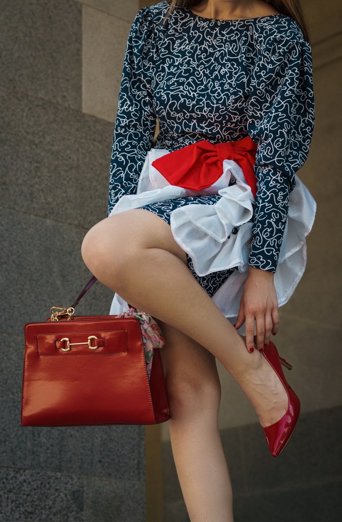 This red, blue and white dress was my mom's prom dress in the late 80s. She designed it and my grandma custom made it for her, with puffy sleeves, a big bow, and three-dimensional chiffon adornments. I wore it with a puffy headband, some red pumps, and an architectural red bag. I'm wearing it in front of the California State Capitol in Sacramento.